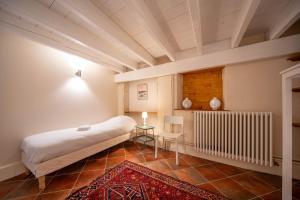 a bedroom with a large bed and a radiator at Le Logis Tournusien in Tournus