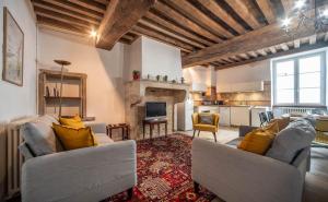 a living room with two couches and a fireplace at Le Logis Tournusien in Tournus
