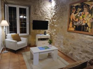 a living room with a couch and a table at Casa de Romaxe in Muros