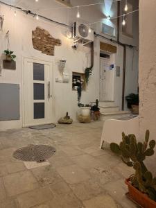 a living room with cactuses and a large room with at Agrimi b&b in Mesagne