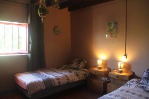 a bedroom with two beds and two lights on the wall at Gîte Charlange in Pradelette