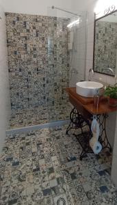 a bathroom with a sink and a mirror at Chrysoula's Guests in Ioannina +11 photos