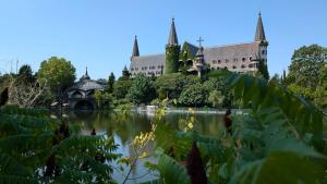 a castle with a lake in front of it at Brisa Apartment in Burgas