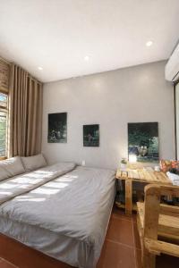 a bedroom with a bed and a desk in it at BG Stone Homestay in Mộc Châu