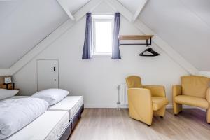 a attic bedroom with a bed and a chair at 6 - Persons Forest 287 Bungalow in Ewijk