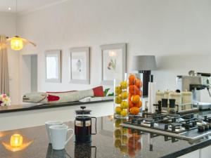 a kitchen with a counter with fruit on it at Walker Bay Villa in Gansbaai