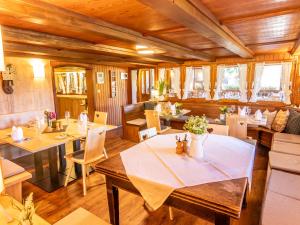 a restaurant with tables and chairs in a room at Schwarzwaldhotel Schmitz in Todtmoos