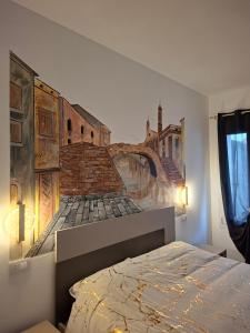 a bedroom with a wall mural of a bridge at Salicornia Rooms in Comacchio