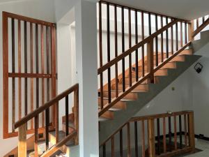 two views of a wooden staircase in a house at SSK Rent Villas in Matara