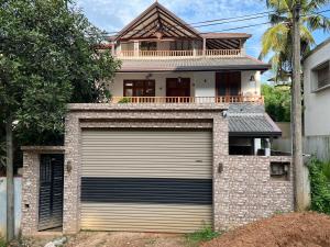 a garage door in front of a house at SSK Rent Villas in Matara