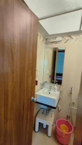 a bathroom with a sink and a mirror at Hideout 2bhk Kharadi Near EON in Pune +2 photos