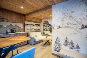 a kitchen and dining room with a drawing on the wall at Appartement Hermine in Les Allues