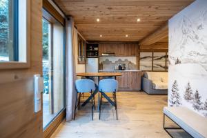 a kitchen and living room with a table and chairs at Appartement Hermine in Les Allues +9 photos