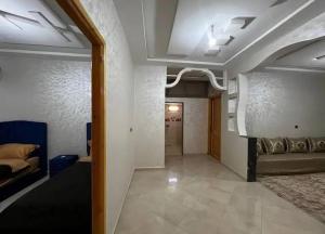 a living room with a couch and a bed in a room at merzouga apartment in Merzouga