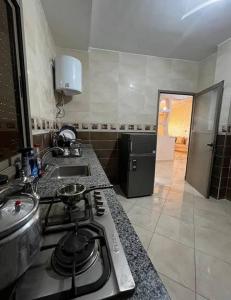 a kitchen with a stove top and a sink at merzouga apartment in Merzouga +2 photos