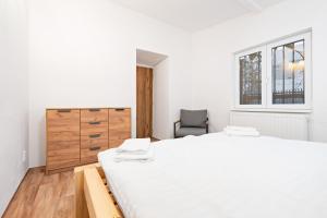 a bedroom with a bed and a dresser and a chair at Na Samotě u tratě in Nepomuk