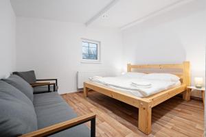 a bedroom with a bed and a couch at Na Samotě u tratě in Nepomuk +53 photos