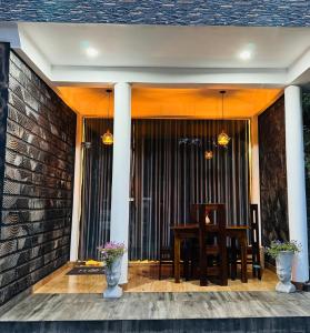 a patio with a table and chairs on a brick wall at Home Away Ella in Ella +22 photos
