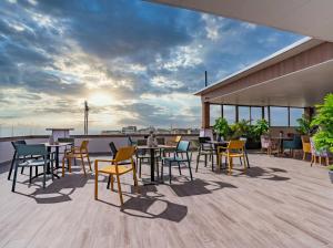 a patio with tables and chairs on a roof at Hotel Rhali Dakhla in Dakhla