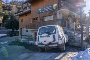 a small car parked in front of a building at Appartement Marmotte in Méribel