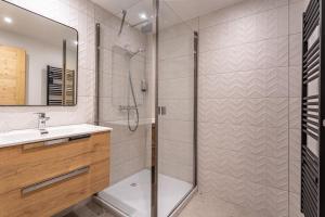 a bathroom with a shower and a sink at Appartement Marmotte in Méribel +3 photos