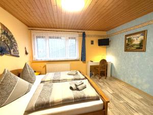 a bedroom with two beds and a desk in it at Ferienwohnung Am Blessberg in Stelzen in Eisfeld