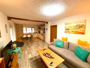 a living room with a couch and a table at Ferienwohnung Am Blessberg in Stelzen in Eisfeld