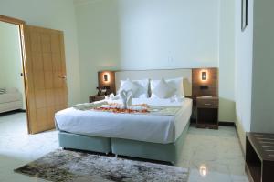 a bedroom with a large bed with white sheets and pillows at History Hotel in Dirē Dawa +24 photos
