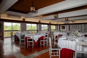 a banquet hall with white tables and chairs and windows at WOT Pateira Soul in Fermentelos