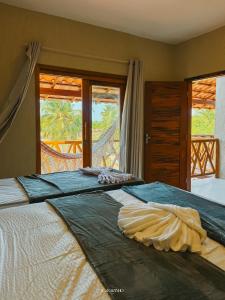 a bedroom with a large bed with a view at Icaraizinho House in Icaraí