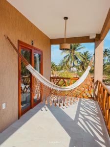 a hammock on the porch of a house at Icaraizinho House in Icaraí