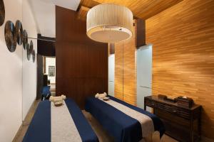 a bedroom with a blue bed and a wooden wall at Courtyard by Marriott Gurugram Downtown in Gurgaon +45 photos