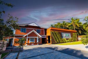 a house with a sign on the side of it at Feliz Homes Kottakkal in Kottakkal