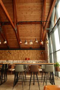 a bar in a restaurant with chairs and lights at Hotel Nordik in Žabljak