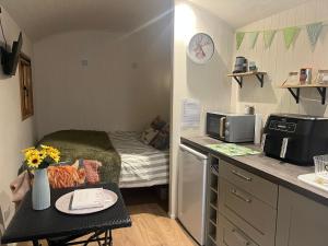a small room with a small kitchen with a bed at Hut in the hall in Bedale