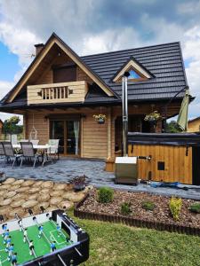 a house with a pool table in front of it at Leśne Zacisze Radawa I in Radawa