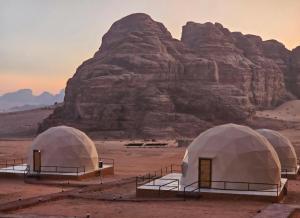 a group of tents in the desert with a mountain at Joker camp Wadi Rum in Disah