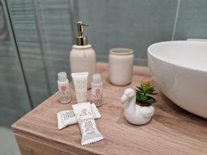 a bathroom with a sink and toiletries on a table at Villa Grazia Pompei in Pompei
