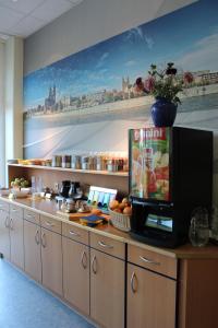 a kitchen with a counter with a microwave at sleep & go Hotel Magdeburg in Magdeburg