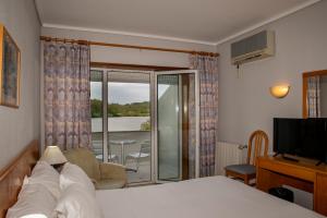 a hotel room with a bed and a balcony at WOT Pateira Soul in Fermentelos