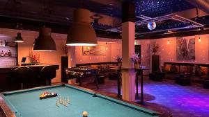 a pool table in a room with a bar at Hotel Lautrup Park in Ballerup