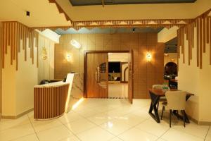 a kitchen and dining room with a table and chairs at Captains Crown Hotels & Resorts in Kushālnagar