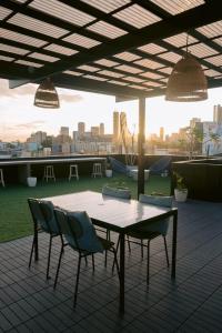 a table and chairs on top of a roof at Canopy Agutaya BGC in Manila