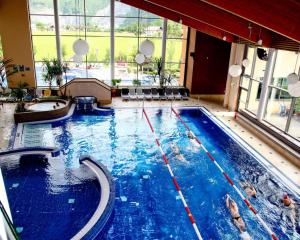 a large swimming pool in a hotel room at Ferienhaus Lechner am Waldrand mit Holzfasssauna & Außendusche, Bergblick und Naturgarten" in Abtenau