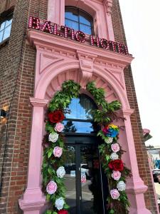 a wreath on a building with a sign on it at The Baltic Hotel in Liverpool