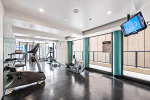 a gym with cardio equipment and a flat screen tv at Urban Oasis City 2 Bed Apartment Oaks Horizons in Adelaide