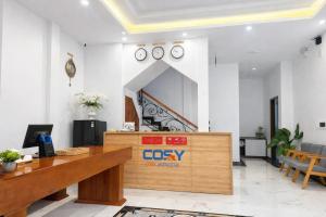 an office with a desk and clocks on the wall at Cosy 2 Homestay in Hue +38 photos