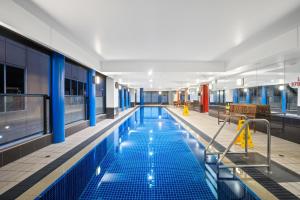 a large swimming pool in a building at Urban Oasis City 2 Bed Apartment Oaks Horizons in Adelaide