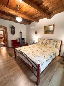 a bedroom with a bed in a room with wooden ceilings at Sziget Vendégház Parád in Parád