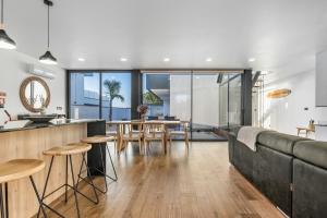 an open kitchen and living room with a couch and a table at Dune House - Villa With Private Dune and Sea View in Viana do Castelo